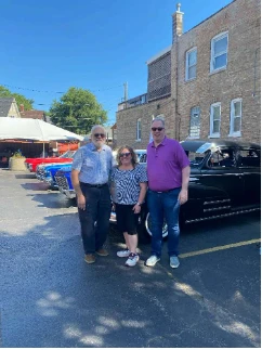 Three attendees enjoying the Route 66 car celebration