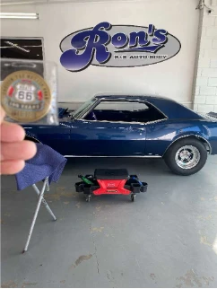 A blue classic car at Ron’s auto shop with a Route 66 commemorative keepsake